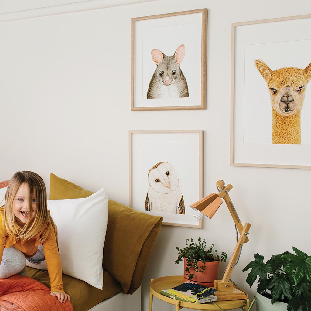 girls bedroom styled with framed animal art prints