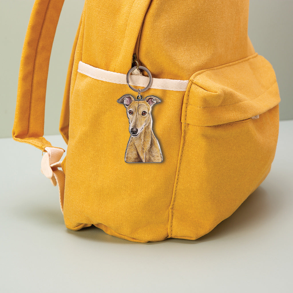 brindle greyhound dog watercolour artwork enamel keychain on yellow canvas backpack