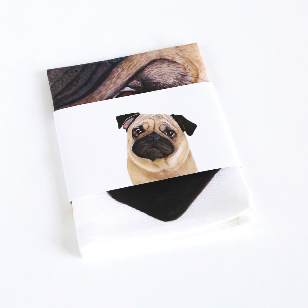 white linen tea towel with fawn pug watercolour artwork packaged
