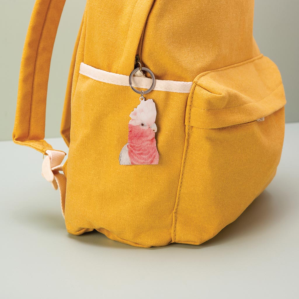 galah australian bird watercolour artwork enamel keychain on mustard canvas backpack
