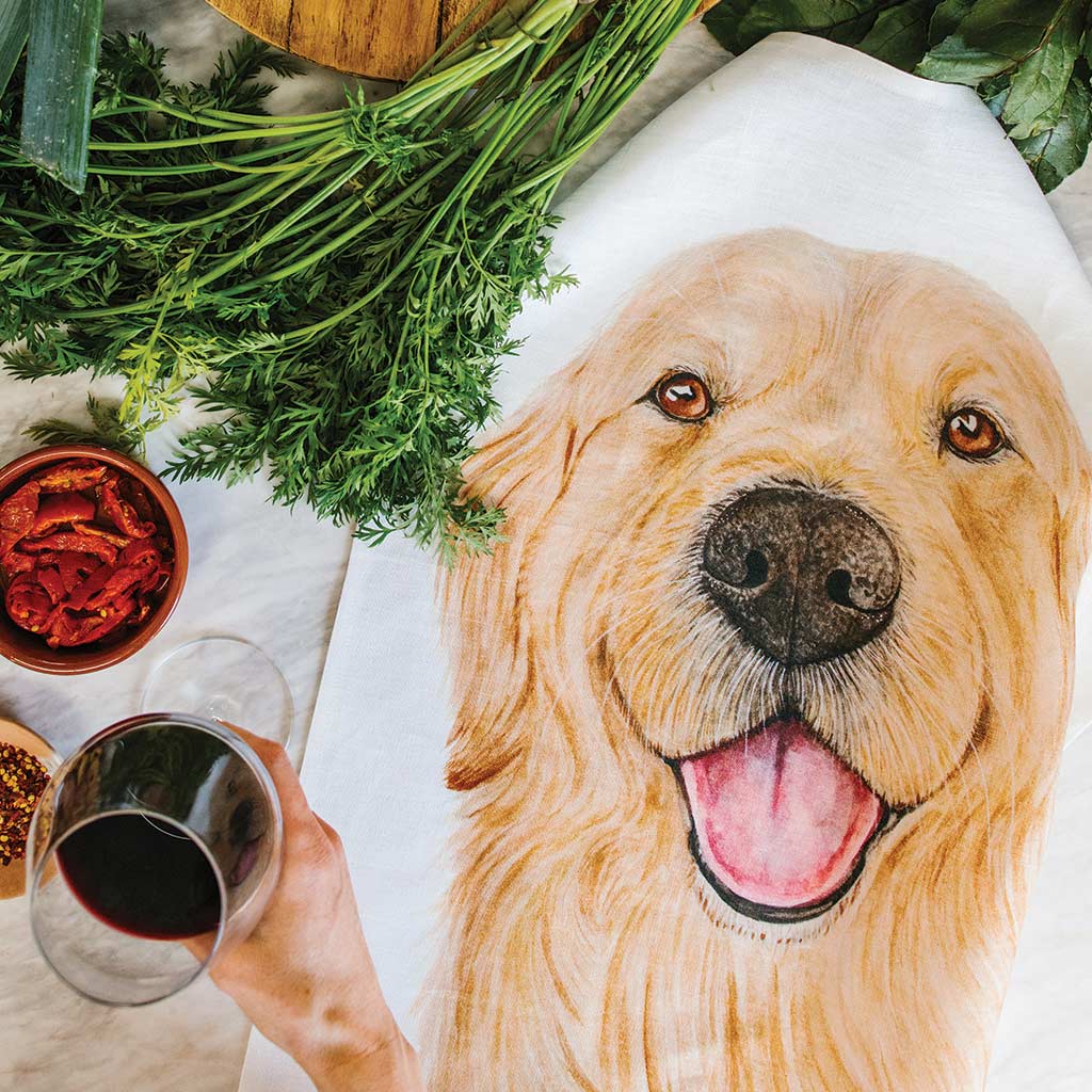 white linen tea towel with golden retriever watercolour artwork in kitchen with food and wine