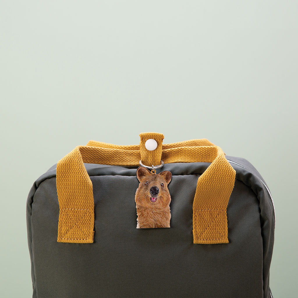 quokka australian animal watercolour artwork enamel keychain on green bag with mustard handles