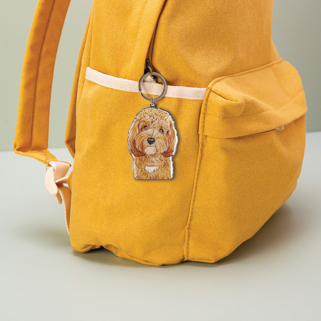 cavoodle dog watercolour artwork enamel keychain on yellow canvas backpack