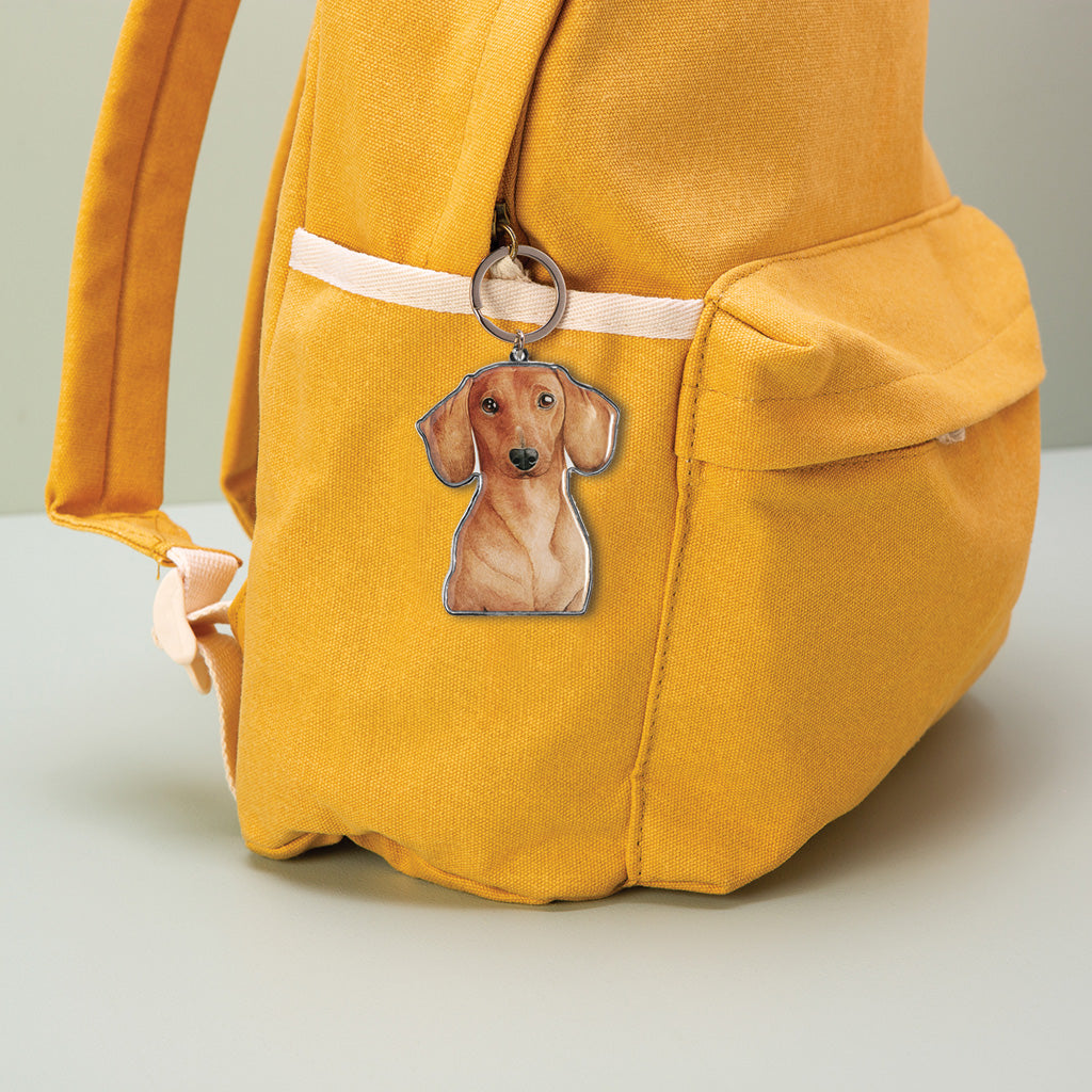 dachshund dog watercolour artwork enamel keychain on yellow canvas backpack