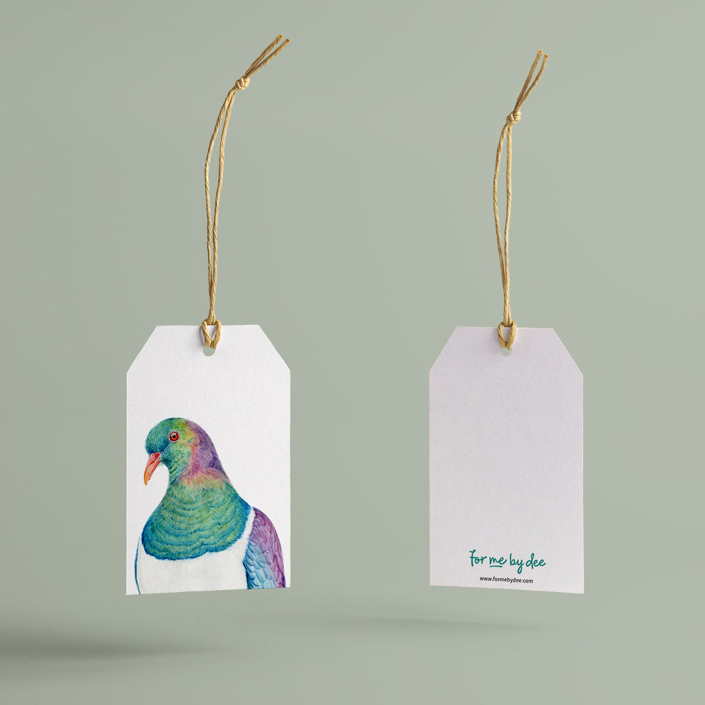 kereru new zealand pigeon painted on gift tag with twine string on green background